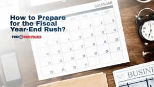 A top-down view of a desk featuring a printed calendar, an alarm clock, and a business newspaper to illustrate the deadlines for Q4 federal contracting 2026.