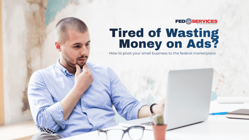A thoughtful small business owner sitting at a desk looking at his laptop to learn how to get government contracts for small business.